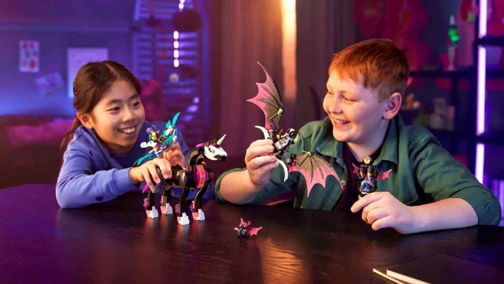 Two children are playing with a LEGO DREAMZzz Pegasus Flying Horse set.
