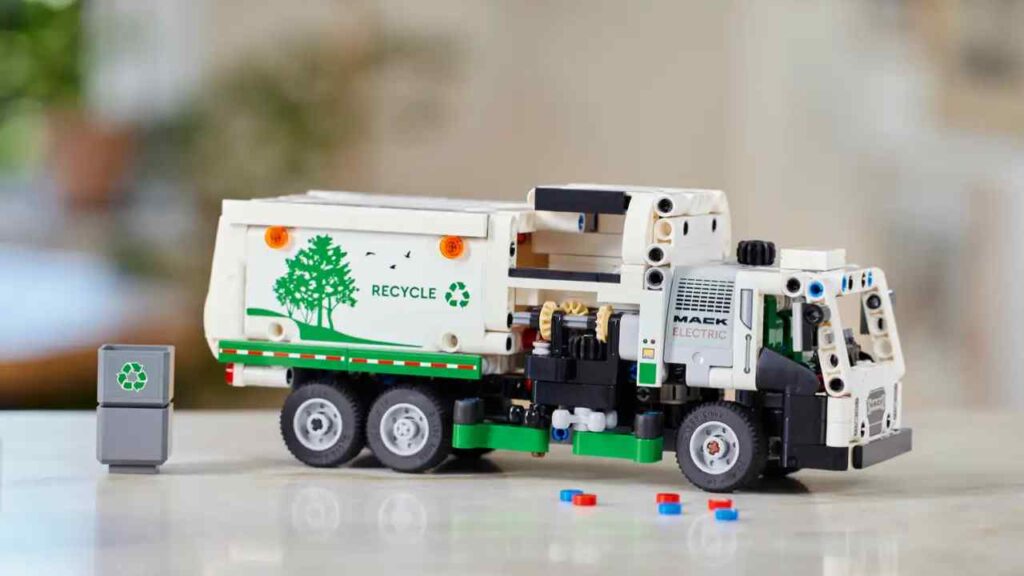 An image of the LEGO Technic Mack LR Electric Garbage Truck against a blurry background.