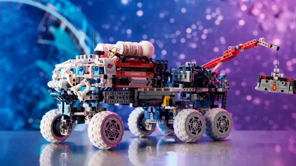 The Mars Crew Exploration Rover from LEGO Technic against a cosmic background.