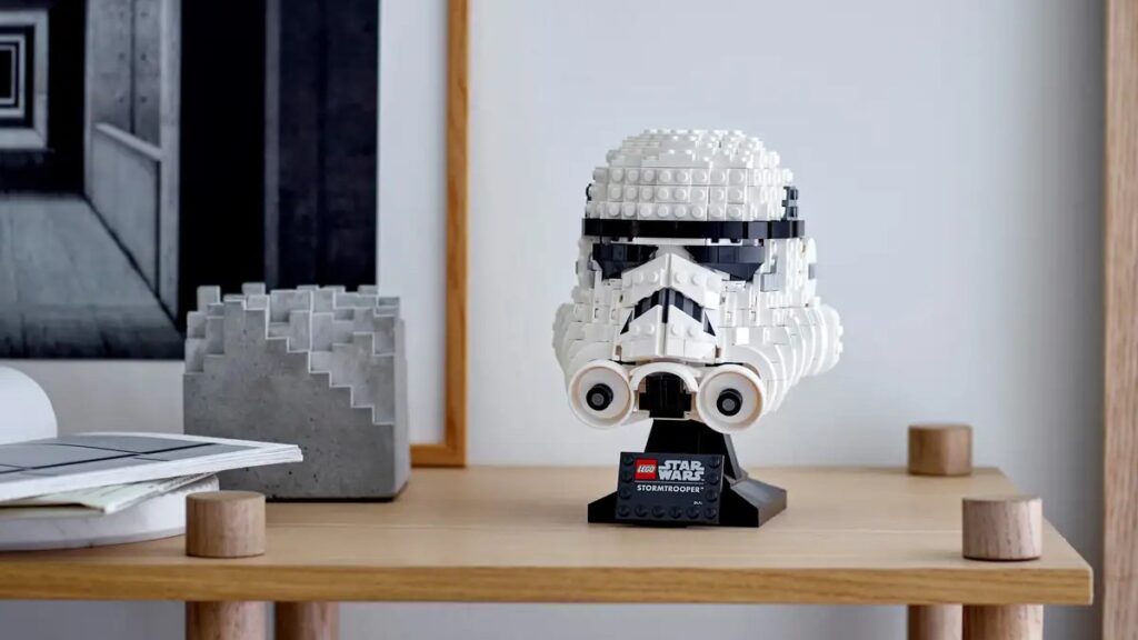 The Stormtrooper helmet is placed on a desk.