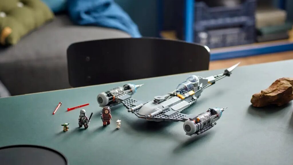 The Mandalorian's starfighter is placed on a desk.